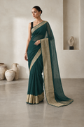 Deep olive chiffon saree with antique gold border.
